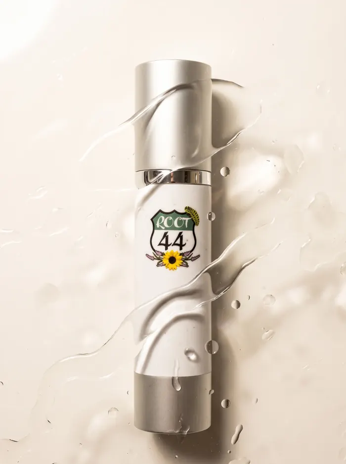 Root 44 Hyaluronic Serum lying in a shallow ripple of water